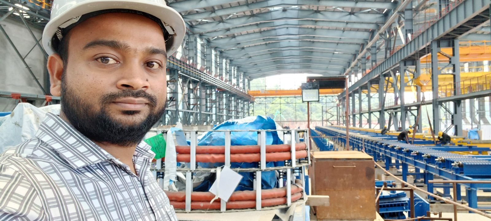 Inside the new rolling mill hall — roller tables and cable carriers before commissioning